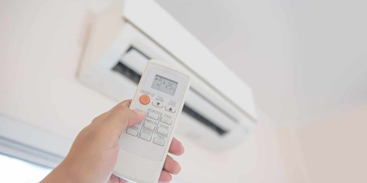 Close up remote set adjust temperature at 25 degrees of air conditioner.